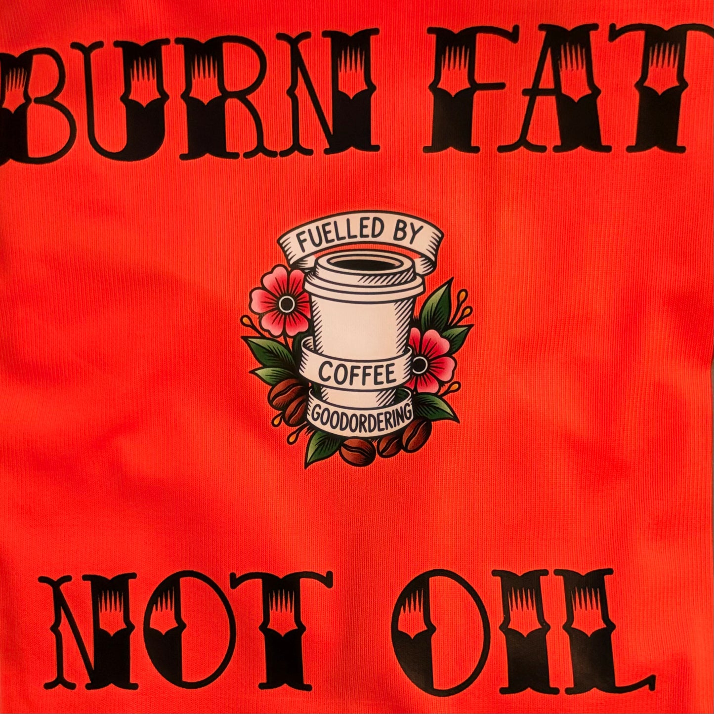 Customised cycling vest bright orange high vis fabric surface with black gothic-style text reading 'BURN FAT' at the top and 'NOT OIL' at the bottom, plus a central coffee cup illustration with flowers and the words 'FUELLED BY COFFEE GOODORDERING'.