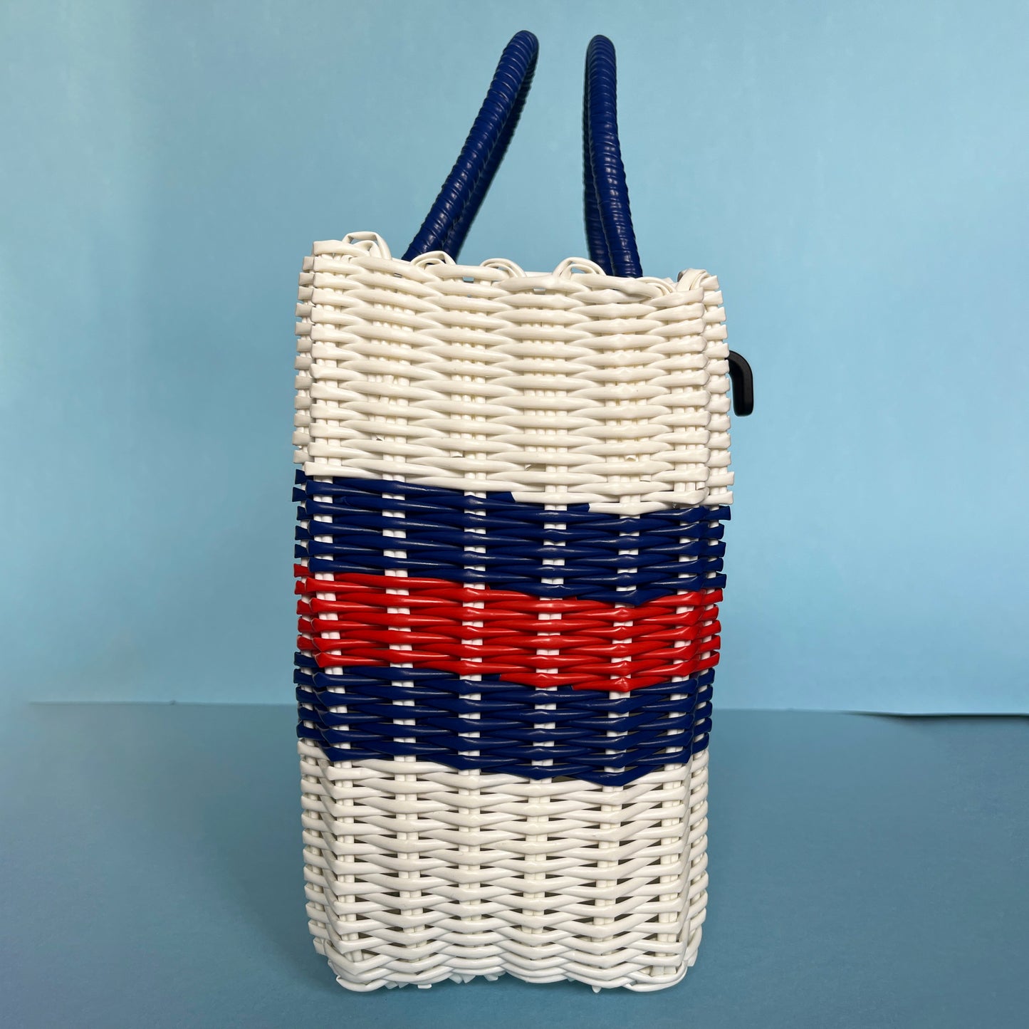 side view red white and blue woven pannier baskets spring basket bag