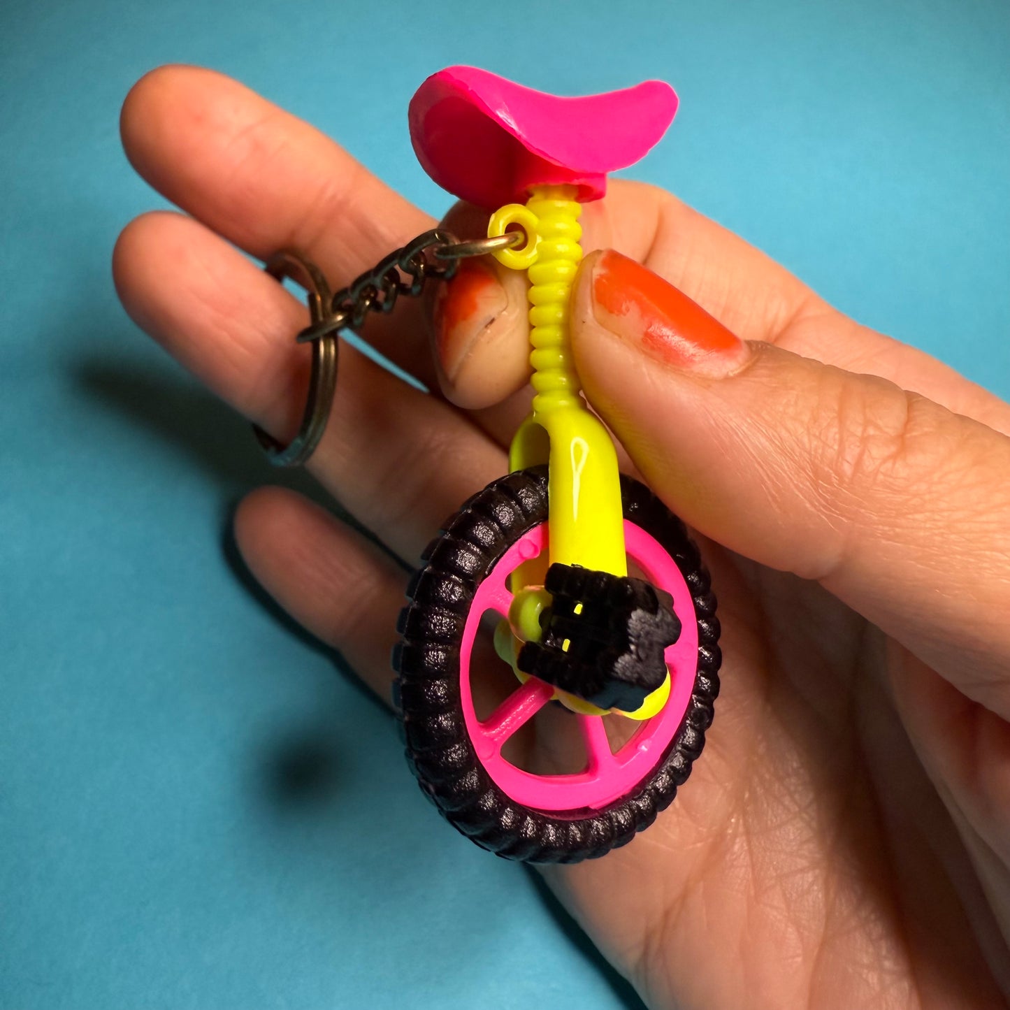 Neon 80s mini unicycle charm keyring