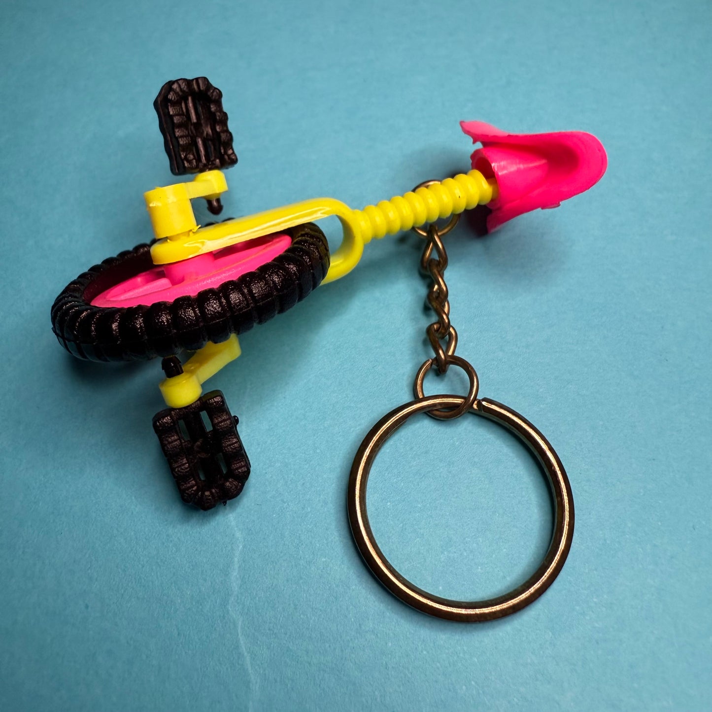 Neon 80s mini unicycle charm keyring