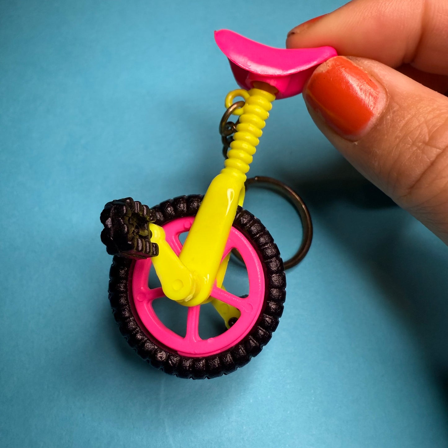 Neon 80s mini unicycle charm keyring