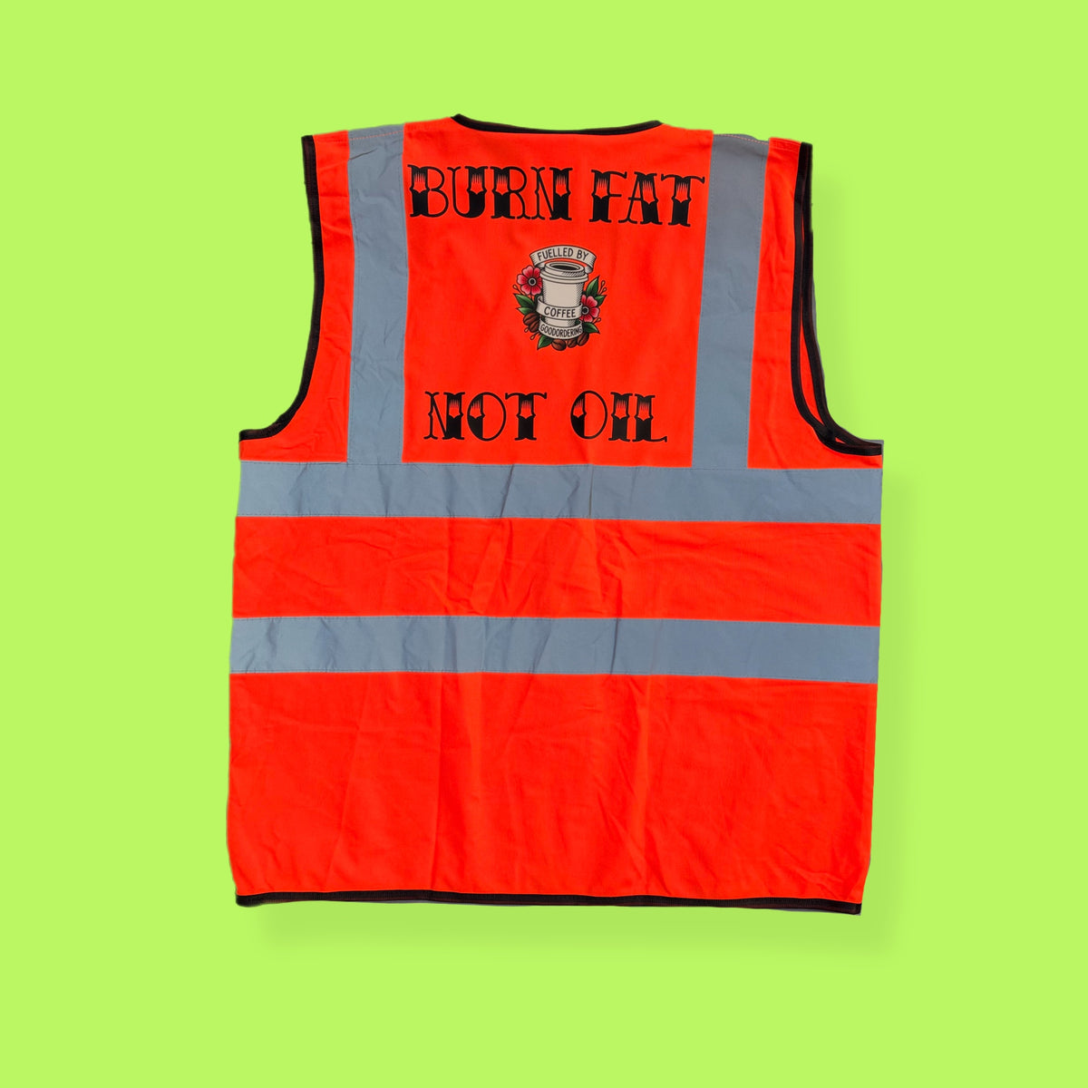 An orange high-visibility safety vest with reflective silver stripes, shown from the back. The back features the text 'BURN FAT NOT OIL' in black lettering around a central graphic of a burning dollar bill. Burn Fat not oil high vis goodordering reflective cycling vest