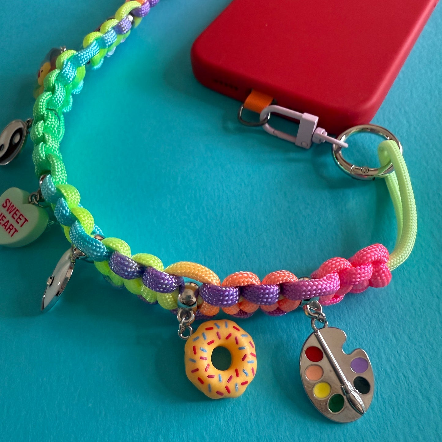 Phone wristler strap with charms