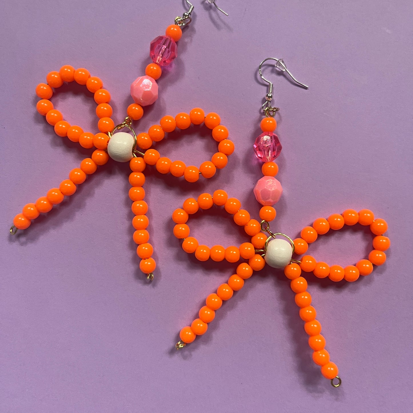 Orange beaded bow earrings