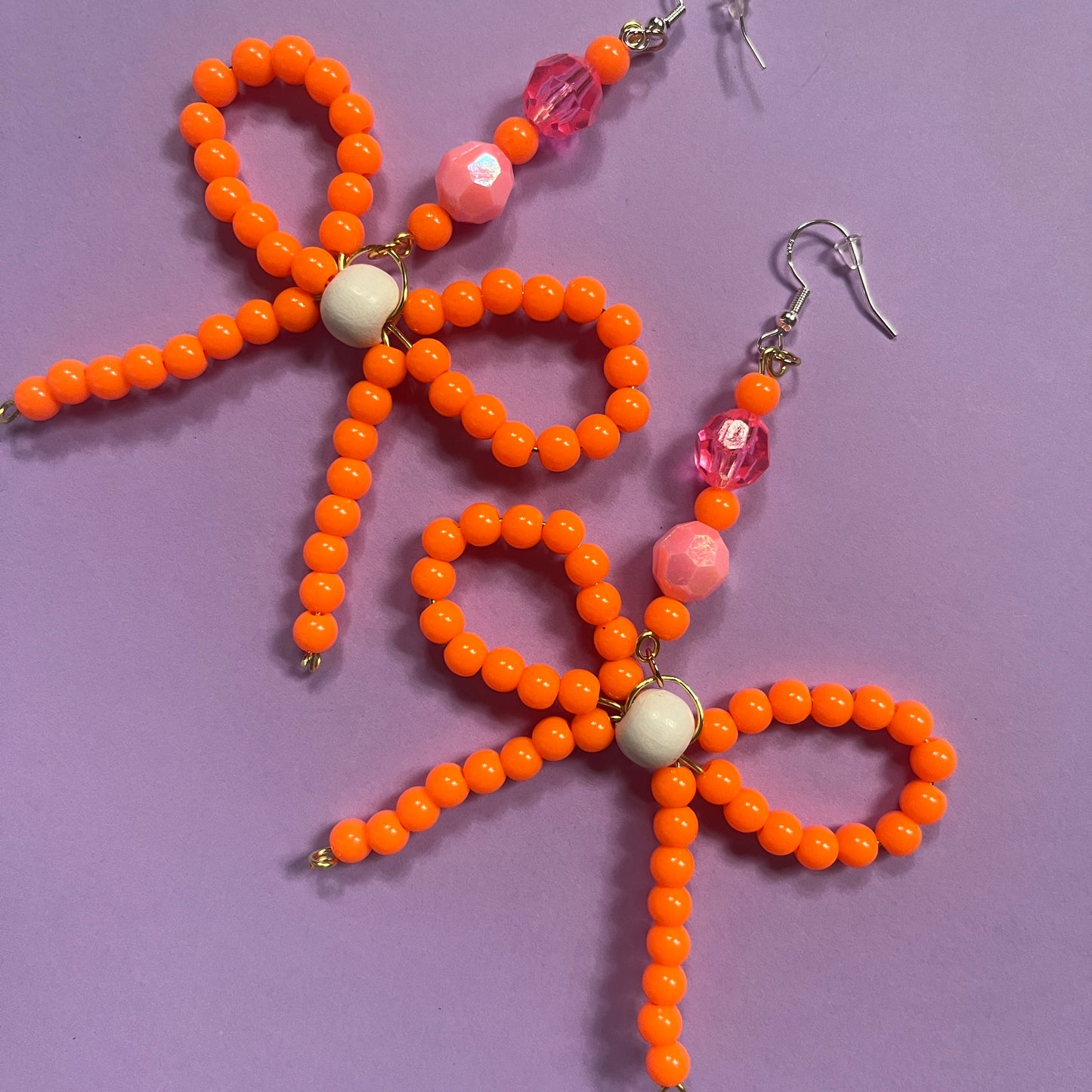 Orange beaded bow earrings