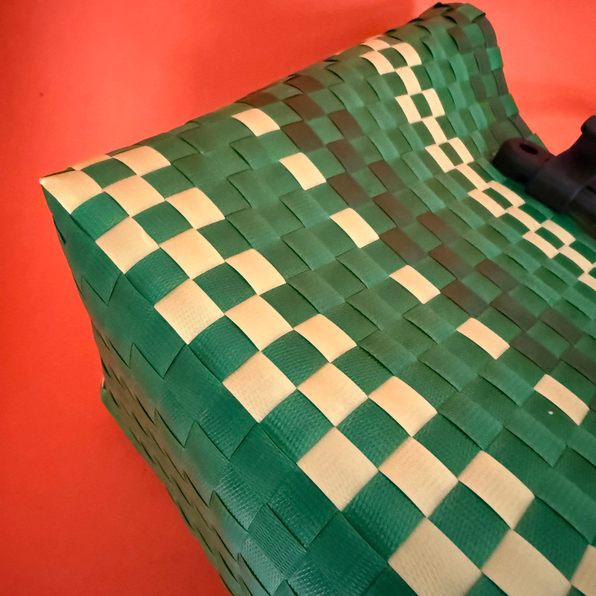 Green bike basket bag showing woven plastic design