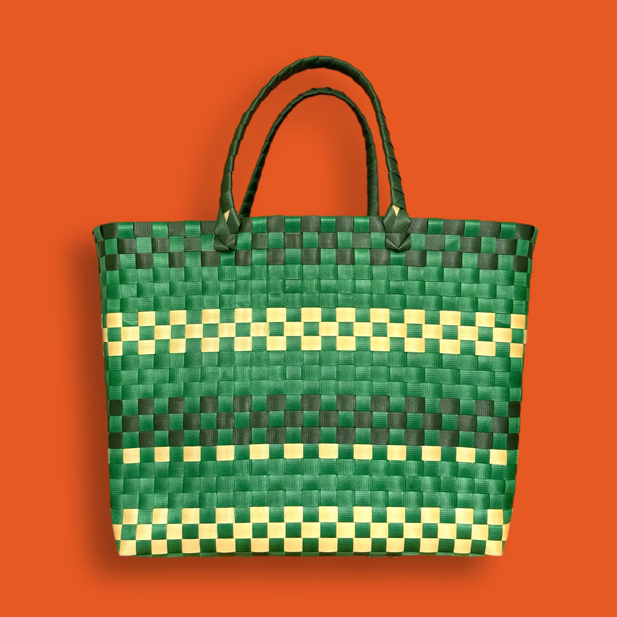 Green plastic woven basket attached to a bicycle