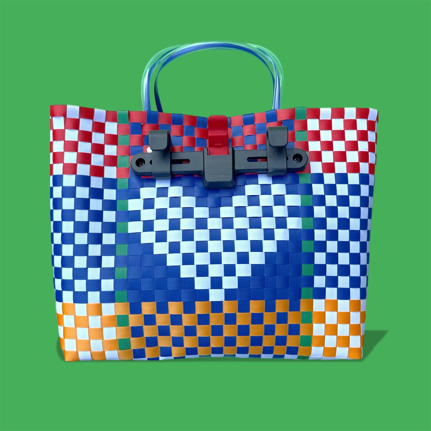Colorful woven bag with a pixelated design on a green background