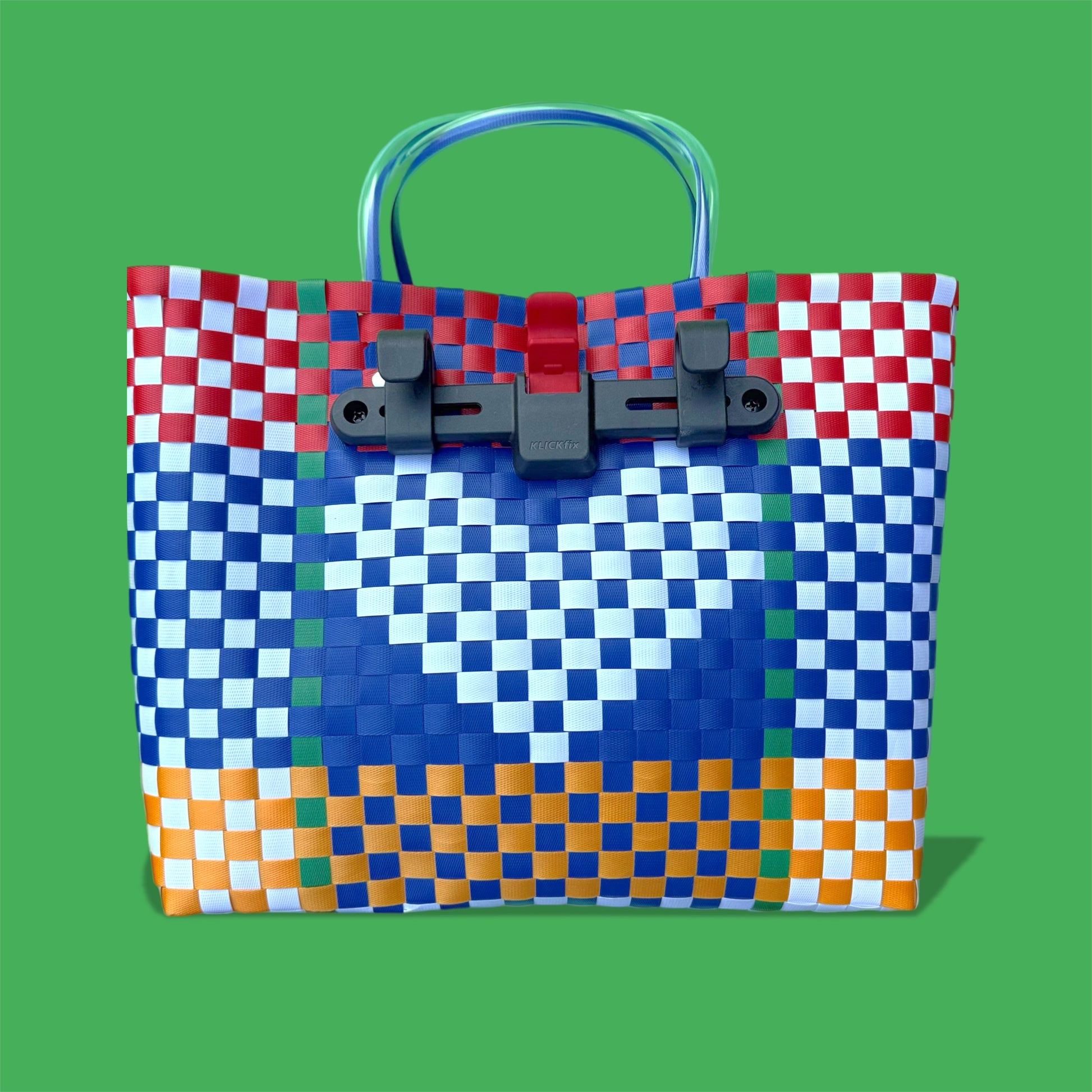 Colorful woven bag with a pixelated design on a green background