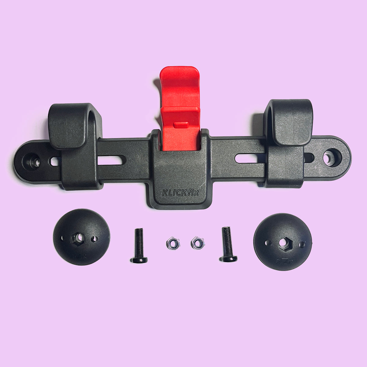 Rixen Kaul Kompakt Rail Pannier system - Goodordering Flat-lay of black KLICKfix rail, red release lever, two dome nuts, screws and washers on pink background