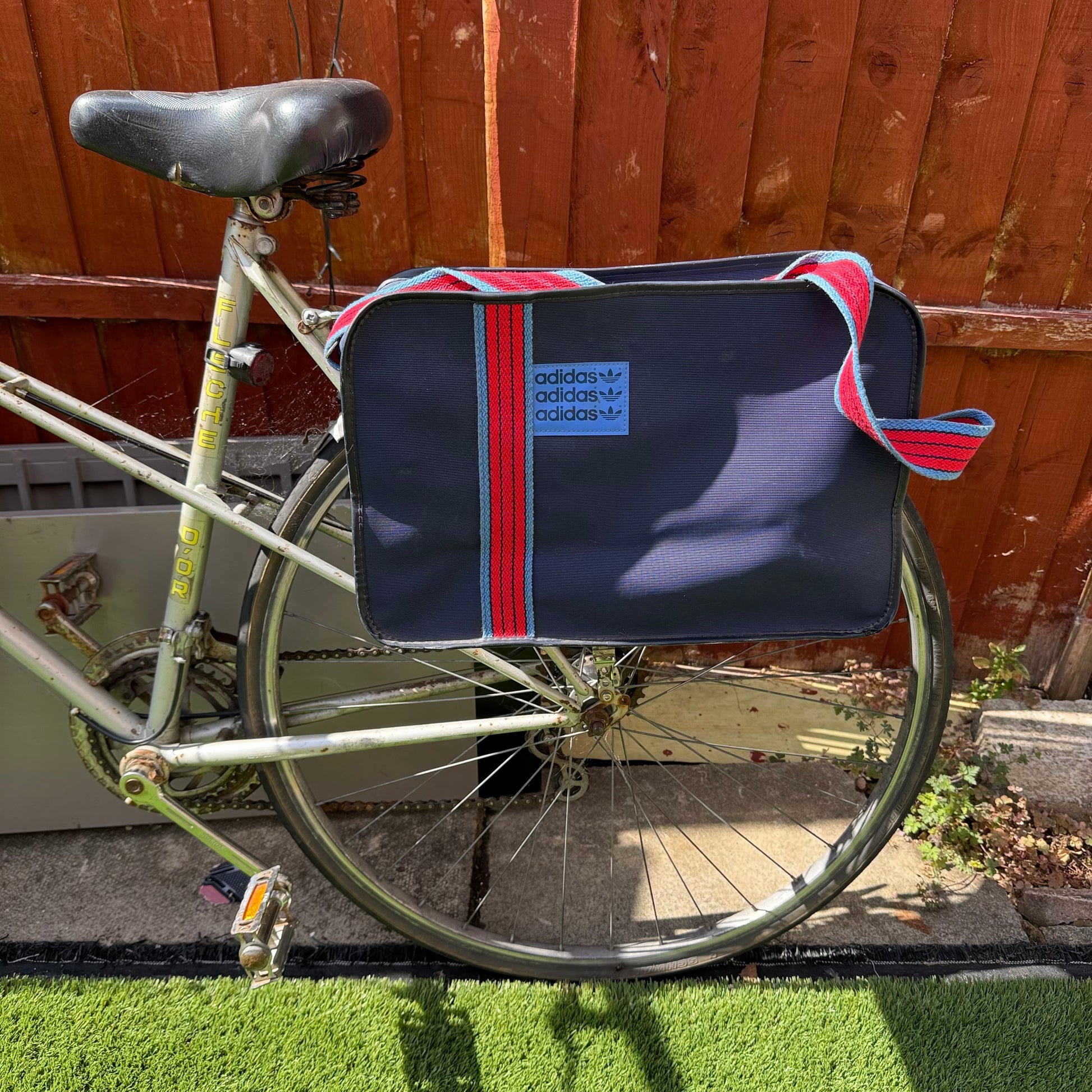 Vintage adidas sports messenger bag attached to a bicycle
