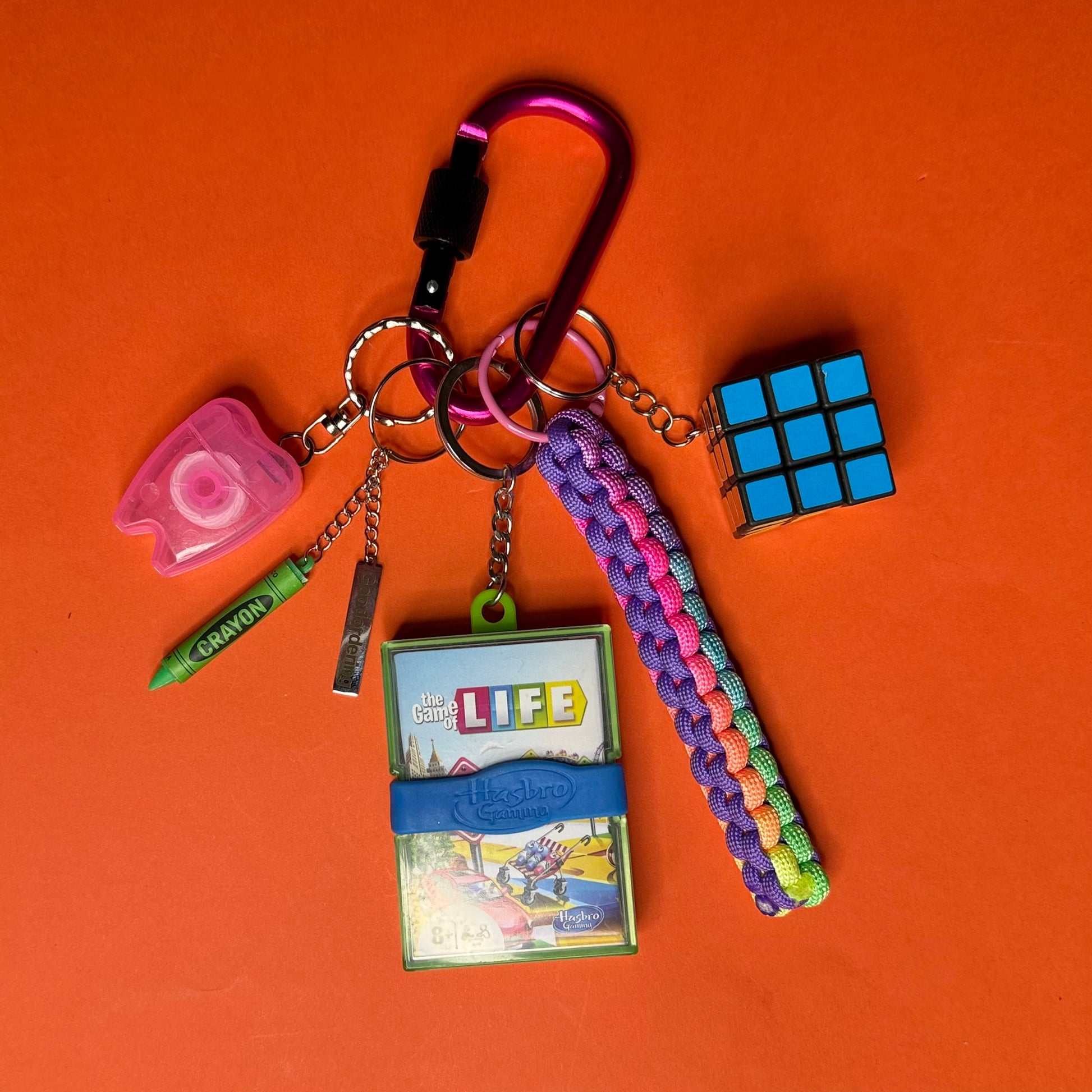 Keychain with various charms on an orange background
