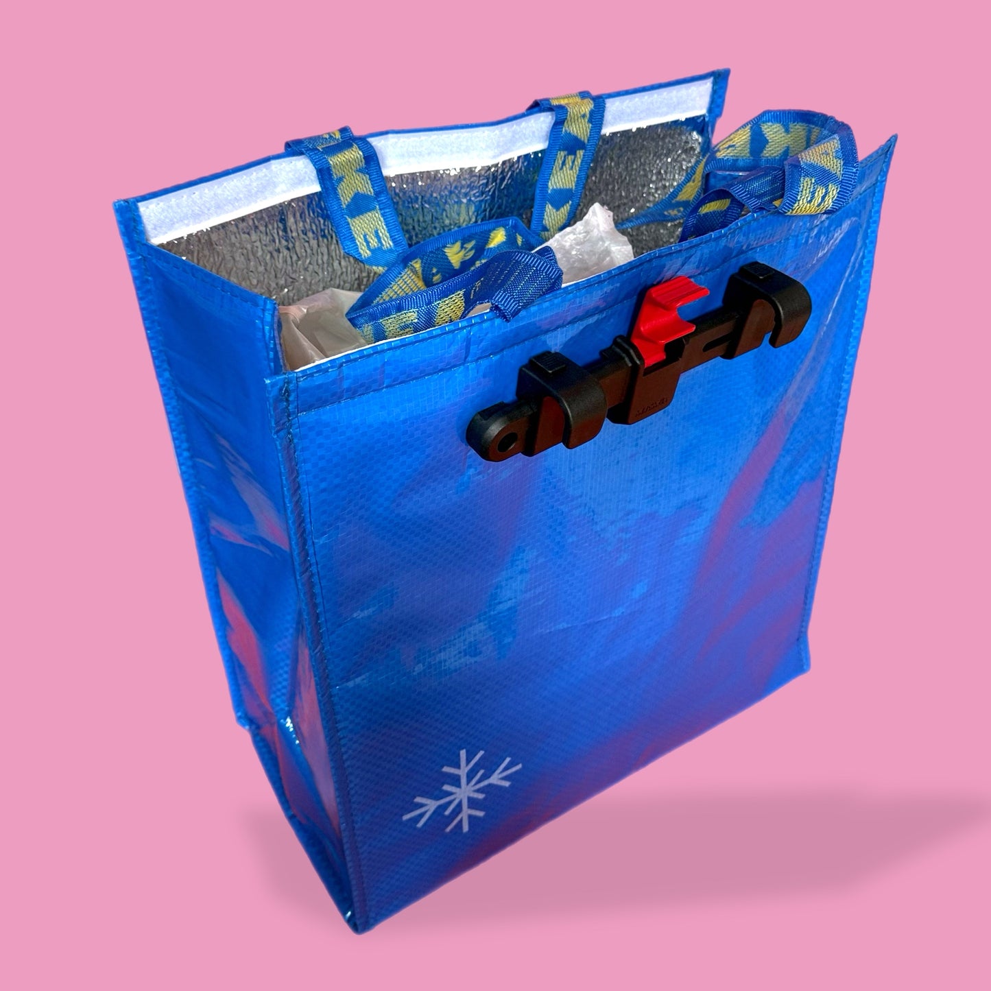 Blue insulated cooler bag with a snowflake logo on a pink background ikea bag 