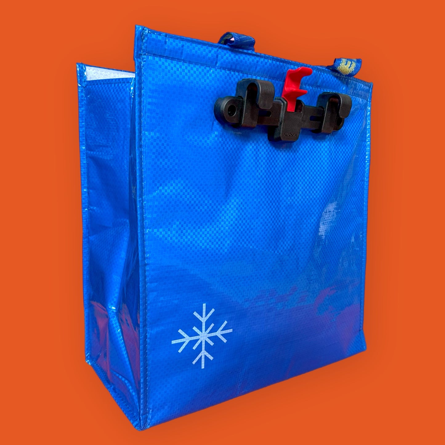 Blue insulated lunch bag with snowflake design on an orange background ikea frakta cool bag 