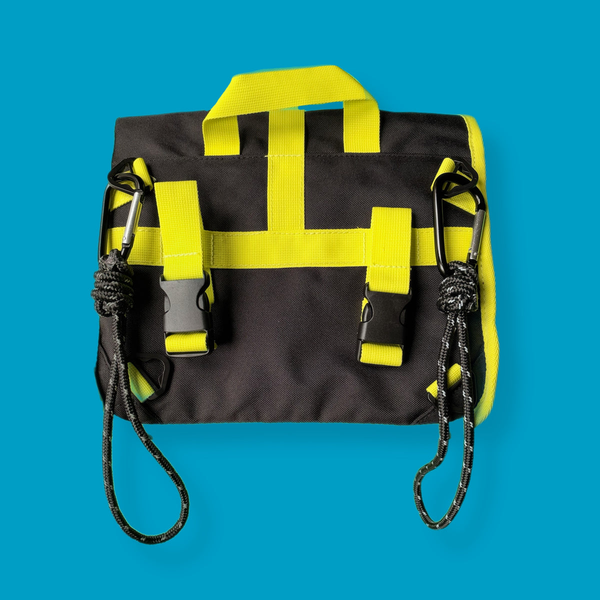 A black and neon yellow high-visibility utility pouch with two black carabiners and rope loops, shown flat against a solid blue background. wheelchair-bag-attachment-straps-goodordering